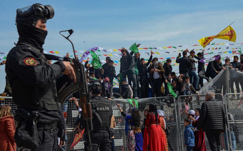 Armed police officers look on as Kurds celebrate Nowruz in Diyarbakir, southeastern Turkey. AFP
