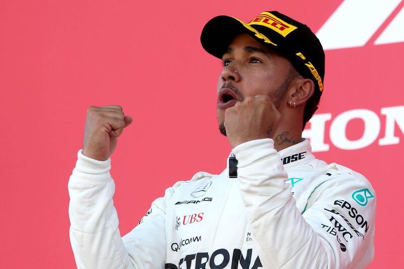 SUZUKA, JAPAN - OCTOBER 07:  Race winner Lewis Hamilton of Great Britain and Mercedes GP celebrates on the podium during the Formula One Grand Prix of Japan at Suzuka Circuit on October 7, 2018 in Suzuka.  (Photo by Charles Coates/Getty Images)