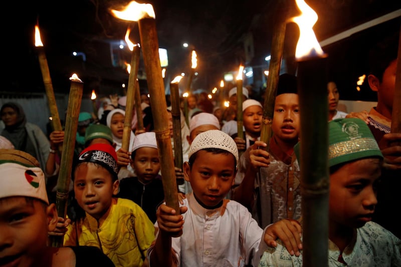 Muslim children carry torches as they take part during a parade ahead of Ramadan at a rural area in Jakarta, Indonesia. Reuters
