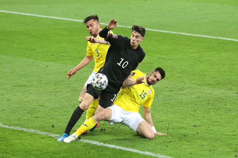 Germany's Kai Havertz of Germany is challenged by Alin Tosca and Andrei Burca of Romania during the World Cup qualifier in Bucharest. Getty