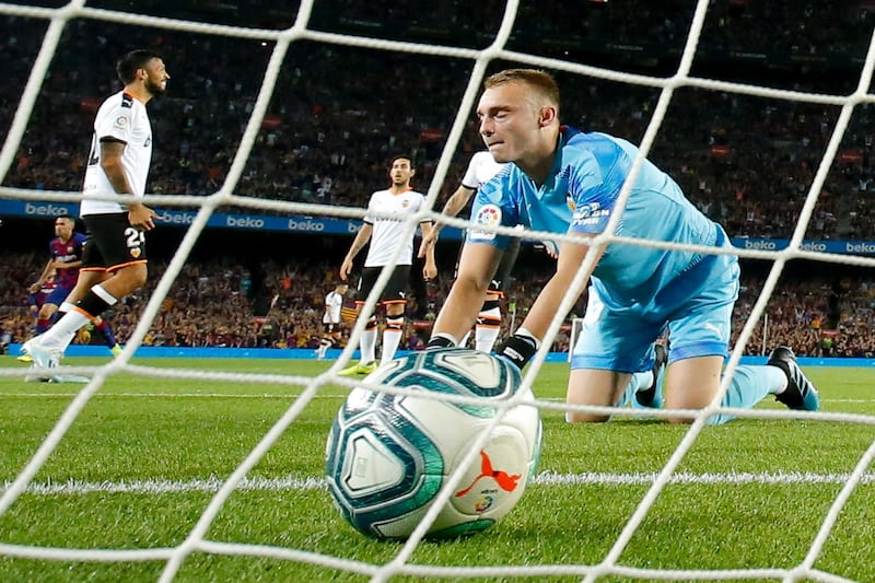 Valencia's Dutch goalkeeper Jasper Cillessen reacts after Barcelona´s Guinea-Bissau forward Ansu Fati scores. AFP