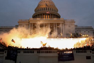 FILE PHOTO: An explosion caused by a police munition is seen while supporters of U.S. President Donald Trump riot in front of the U.S. Capitol Building in Washington, U.S., January 6, 2021. REUTERS/Leah Millis/File Photo