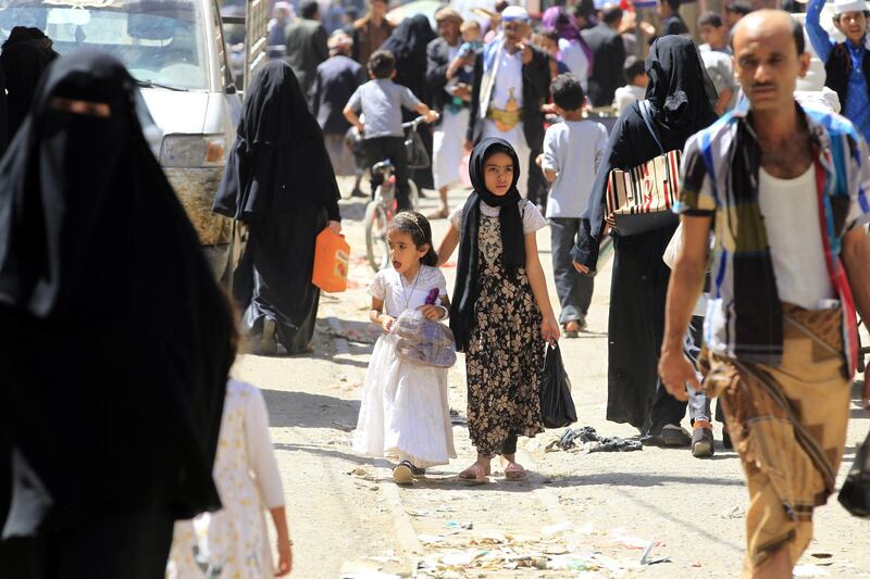 Yemenis walk through a market in Sanaa, Yemen. EPA