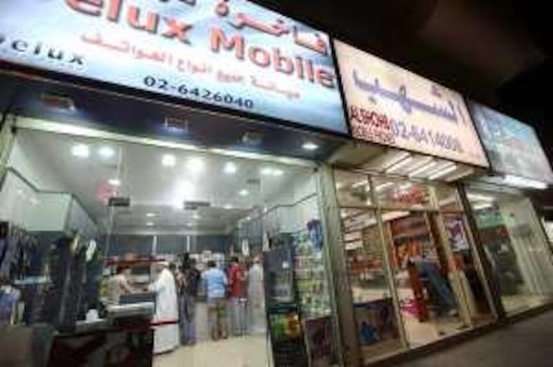 May 3, 2010/ Abu Dhabi /  Mobile phone stores line the street along 11th Street in Abu Dhabi May 3, 2010. (Sammy Dallal / The National)



