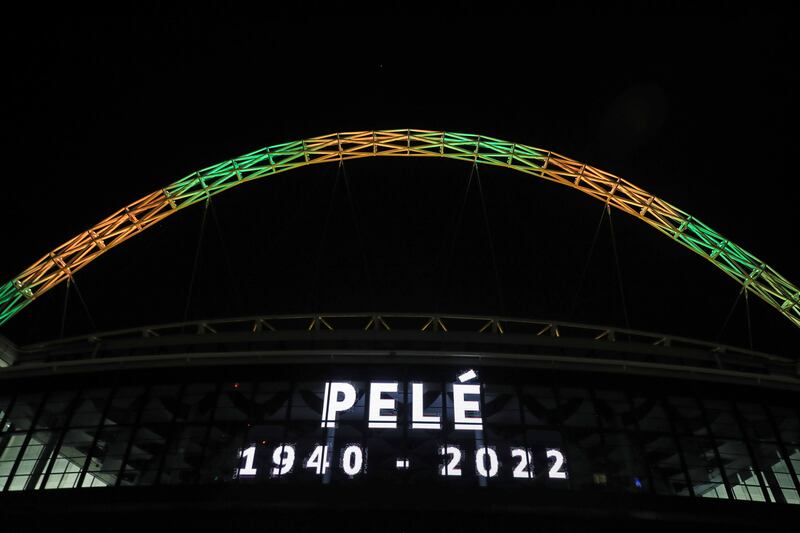 Wembley Stadium's arch is lit up in the colours of Brazil to pay tribute to Pele. PA