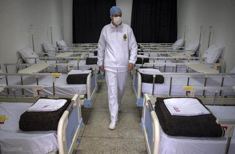 A member of the medical staff at Moroccos's military field hospital in Nouaceur, South of Casablanca, inspects the beds as they prepare to receive patients of the coronavirus pandemic.  AFP