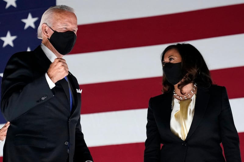 FILE- In this Aug. 20, 2020, file photo Democratic presidential candidate former Vice President Joe Biden pumps his fist on stage with his running mate Sen. Kamala Harris, D-Calif., during the fourth day of the Democratic National Convention at the Chase Center in Wilmington, Del. (AP Photo/Andrew Harnik, File)