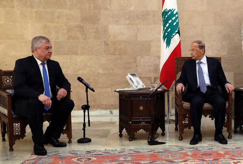 In this photo released by Lebanon's official government photographer Dalati Nohra, Russia's special presidential envoy to Syria Alexander Lavrentiev, left, meets with Lebanese President Michel Aoun, at the presidential palace, in Baabda east of Beirut, Lebanon, Thursday, July 26, 2018. The Russian delegation is in Lebanon to discuss Russian proposals for organizing the return of Syrian refugees from Lebanon and Syria to their homes in Syria. (Dalati Nohra via AP)