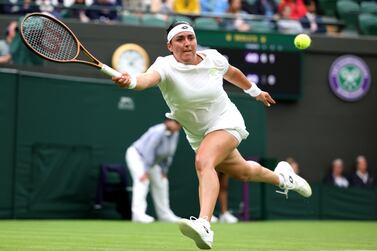 LONDON, ENGLAND - JULY 04: Ons Jabeur of Tunisia stretches to play a forehand against Magdalena Frech of Poland in the Women's Singles first round match during day two of The Championships Wimbledon 2023 at All England Lawn Tennis and Croquet Club on July 04, 2023 in London, England. (Photo by Michael Regan / Getty Images)