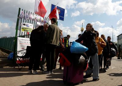 Ukrainian refugees after crossing the border into Poland to flee the Russian invasion. Reuters