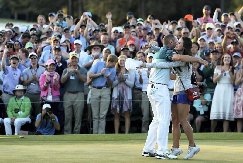 AUGUSTA, GA - APRIL 09: Sergio Garcia of Spain embraces fiancee Angela Akins in celebration after defeating Justin Rose (not pictured) of England on the first playoff hole during the final round of the 2017 Masters Tournament at Augusta National Golf Club on April 9, 2017 in Augusta, Georgia.   David Cannon/Getty Images/AFP