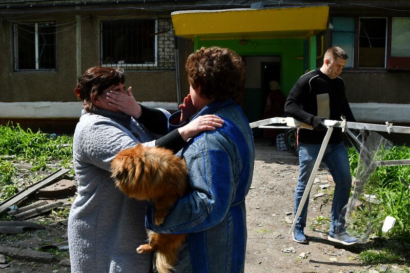 Shocked occupants of an apartment building in Kramatorsk, Donbas, that was destroyed by overnight shelling . AP