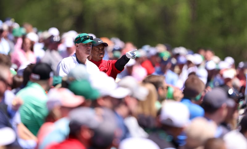 Tiger Woods and Joe LaCava discuss his tee shot on the 12th hole during the final round of the Masters. EPA