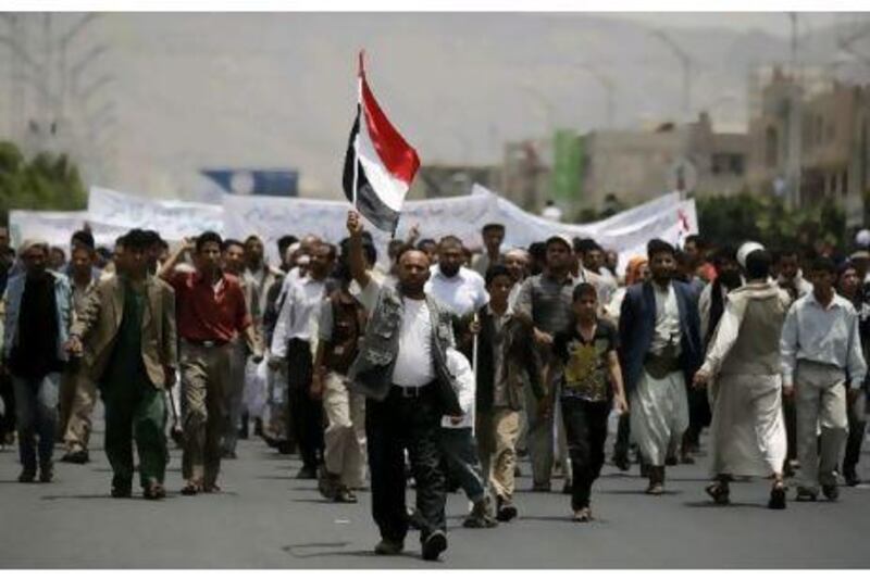 Yemenis who live in a neighbourhood near the site of anti-government demonstrations hold a counter-demonstration demanding that the protestors leave the area in Sanaa yesterday.