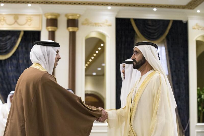 Sheikh Mohammed bin Rashid, Vice-President and Ruler of Dubai, greets Sheikh Mansour bin Zayed, Deputy Prime Minister and Minister of Presidential Affairs, during a swearing-in ceremony for the Cabinet ministers.