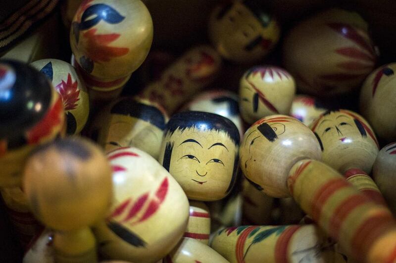 Traditional Kokeshi dolls from Japan’s northern Tohoku area are piled up in a box at Boroichi flea market in Tokyo. Thomas Peter / Reuters