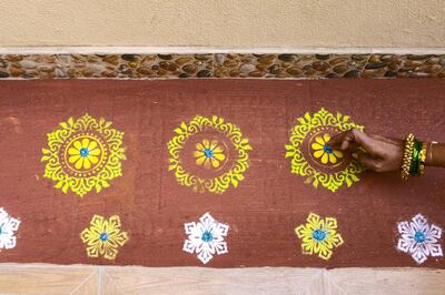 DUBAI, UNITED ARAB EMIRATES - NOVEMBER 6, 2018. 

Nivedita Khursude works on the rangoli at her patio in preparation for Diwali.

(Photo by Reem Mohammed/The National)

Reporter:
Section:  WK