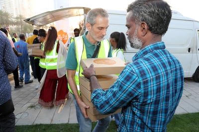 Iftar meals are distributed at Zabeel Park in Dubai as part of the UAE Food Bank's 'One thousand meals' programme. Pawan Singh / The National