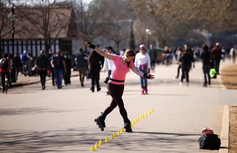 A woman roller skates through Hyde Park in London. Reuters