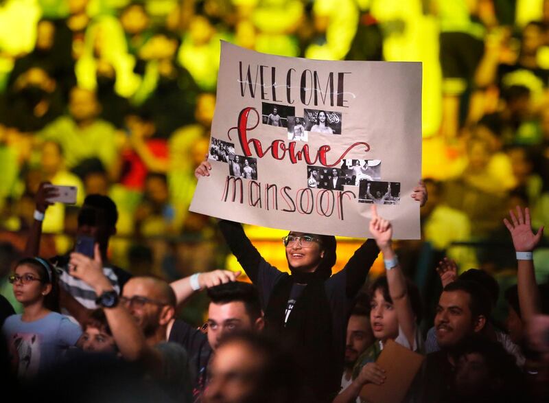 A woman shows his support for Mansoor. AP Photo