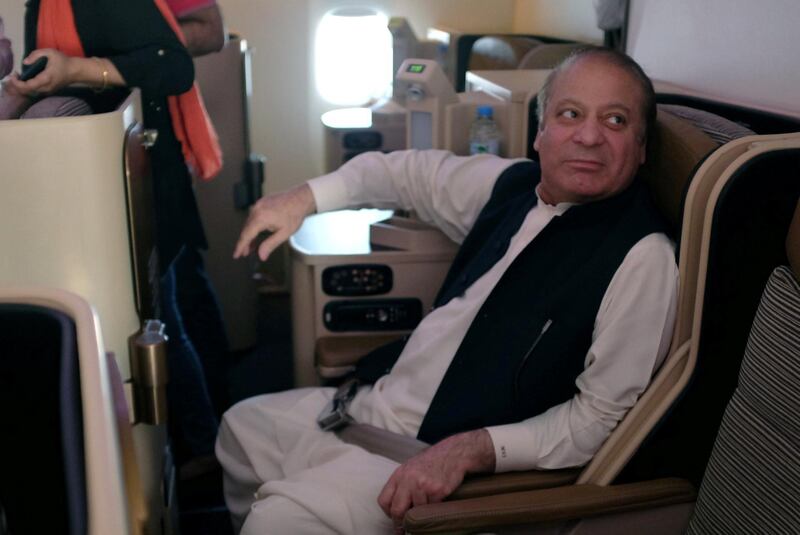 Ousted Pakistani Prime Minister Nawaz Sharif sits on a plane after landing at the Allama Iqbal International Airport in Lahore. Reuters