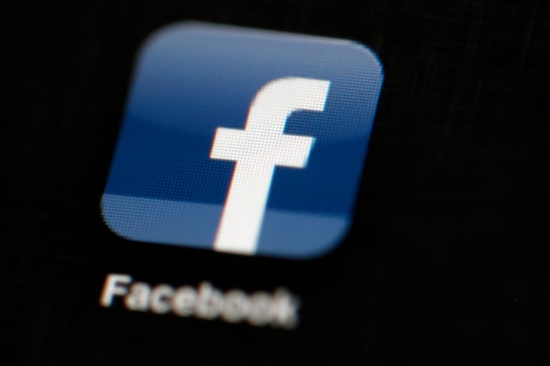 FILE - In this May 16, 2012, file photo, the Facebook logo is displayed on an iPad in Philadelphia. Facebook told The Associated Press on Aug. 16, 2017,  it has banned the Facebook and Instagram accounts of one of a white nationalist who attended a rally in Charlottesville, Virginia, that ended in deadly violence. (AP Photo/Matt Rourke, File)