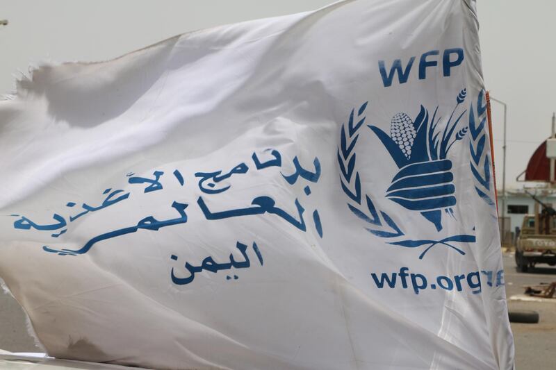 epa07735655 A flag of the World Food Program (WFP) waves on a vehicle carrying a team of the WFP at the key grain storage silos in the war-torn city of Hodeidah, Yemen, 23 July 2019. According to repowers, a team of the World Food Program (WFP) visited the key grain storage silos in the port city of Hodeidah, a month after the UN agency began partially suspending aid to the Houthi-controlled areas of Yemen, affecting 850,000 beneficiaries only in the capital Sanaâ€™a. The UN agency delivers monthly rations or money to 10.2 million people of Yemen's 26-million population.  EPA/NAJEEB ALMAHBOOBI