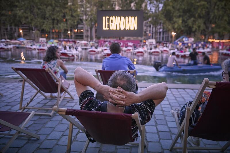 Parisians watch Paris Plages's Le Cinema Sur L'Eau, a floating cinema at La Villette. Getty Images