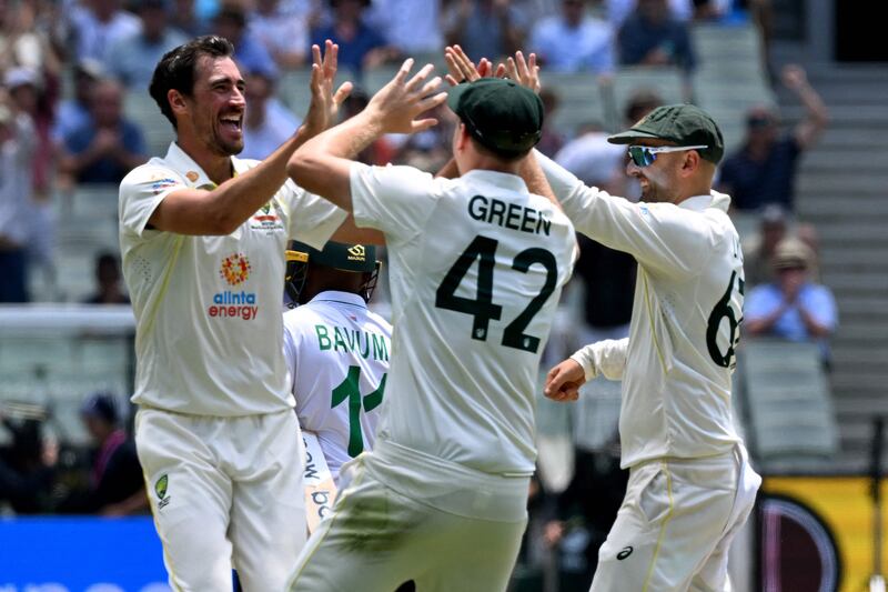 Australian bowler Mitchell Starc, left, celebrates dismissing South African batsman Temba Bavuma. AFP