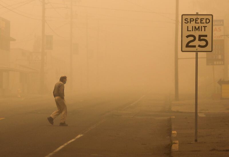 A man walks through a haze of smoke in Molalla, Oregon. Reuters