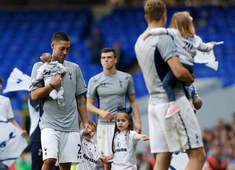 Tottenham Hotspur's Clint Dempsey, left, with his children parade around the ground to mark the last match of the season at the end of their English Premier League soccer match against Sunderland at White Hart Lane, London, Sunday, May 19, 2013. (AP Photo/Sang Tan) *** Local Caption ***  Britain Soccer Premier League.JPEG-0a13e.jpg