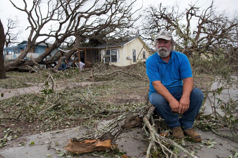 David Graves takes a break from clearing trees to his home after Harvey. It is the worst storm to hit the area in 50 years. Courtney Sacco / Corpus Christi Caller-Times via AP