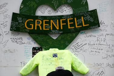 A man kneels during a commemoration to mark the third anniversary of the Grenfell Tower fire in London, Britain June 14, 2020. Reuters