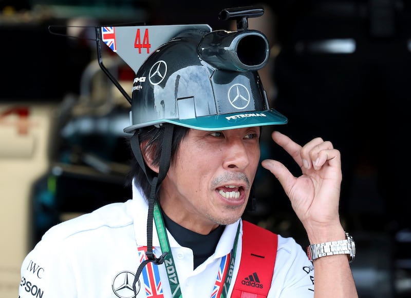 A Mercedes fan waits for the start of the third practice session for the Japanese Formula One Grand Prix at Suzuka. Eugene Hoshiko / AP Photo.