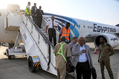 Passengers and crew leave an EgyptAir plane after landing at Port Sudan airport. AFP