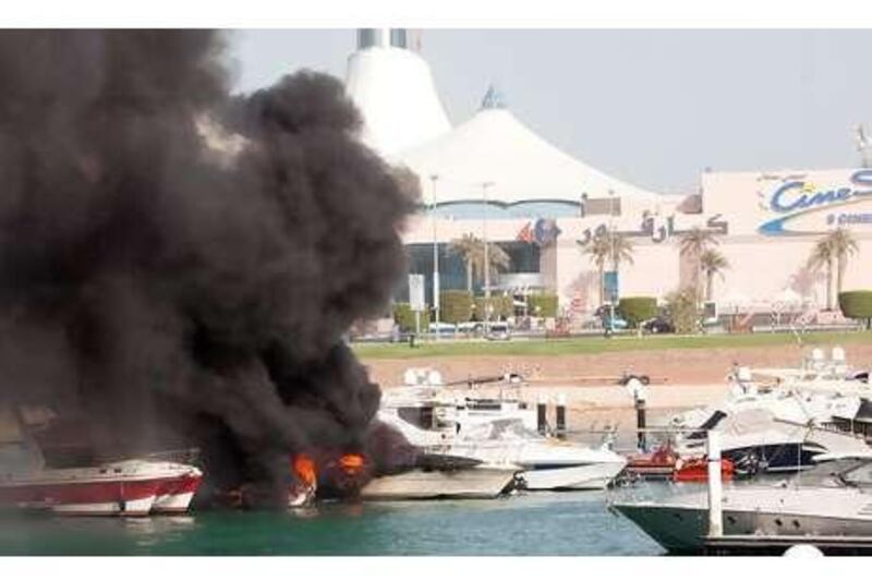 A boat burns in its berth near Marina Mall in Abu Dhabi. Some owners have criticised the lack of safety equipment.