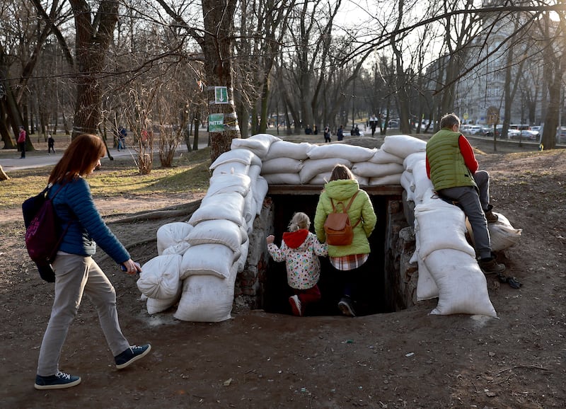 People head for an air raid shelter after sirens sound across Lviv in Ukraine. Getty