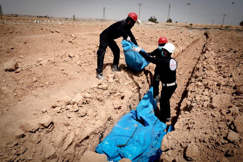 Bodies retrieved from the rubble of the city are buried in mass graves in Raqqa outskirts. Photo: David Pratt for The National