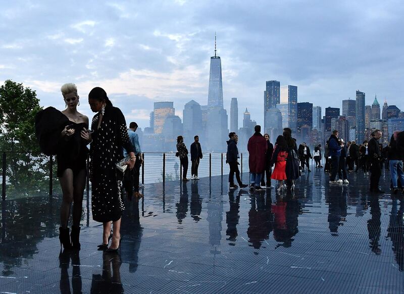 Guests stand on the runway in front of the Manhattan skyline before the Saint Laurent Men's Spring/Summer 2019 collection during a runway show in Liberty State Park in Jersey City, New Jersey. Angela Weiss / AFP