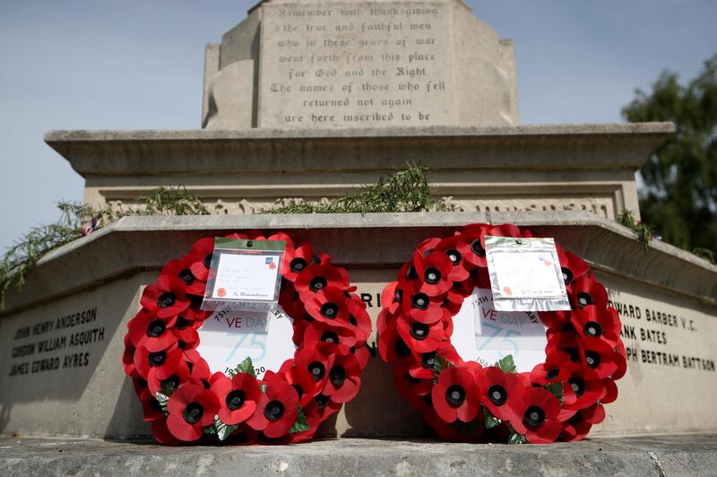 Poppy wreaths on a war memorial at Saint Peter and St Paul Church in Tring, United Kingdom. Getty Images