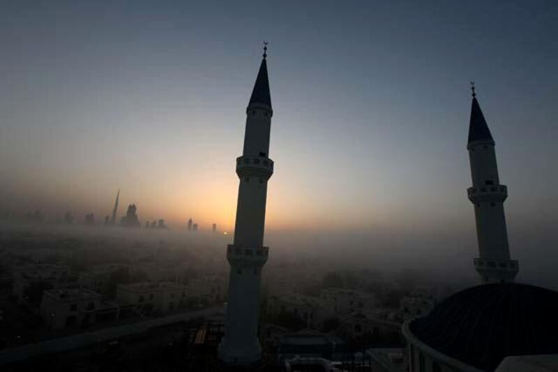 
DUBAI, UNITED ARAB EMIRATES Ð April 20,2011: Minarets of the under construction Farooq Mosque during the sunrise in Al Safa area in Dubai. Dubai skyline can be seen on the left side.  (Pawan Singh / The National) For News. Story by James
