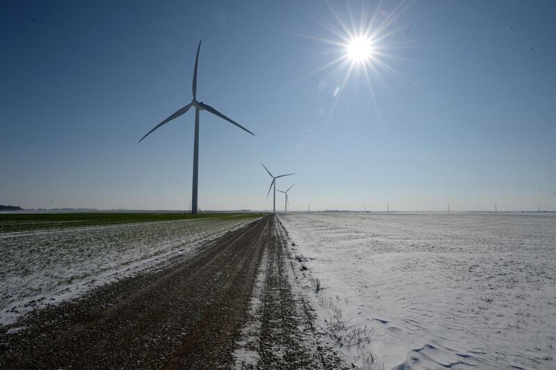 This picture taken on February 10, 2021 shows wind turbines after overnight snowfall, near Illiers-Combray, central France. (Photo by JEAN-FRANCOIS MONIER / AFP)