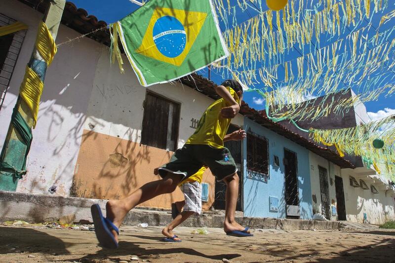 A boy runs in a decorated street in Fortaleza, Brazil. EPA