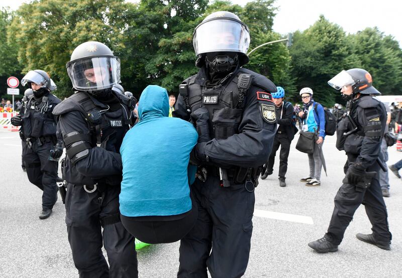 German police remove protesters  blocking a street  in Hamburg. Fabian Bimmer / Reuters