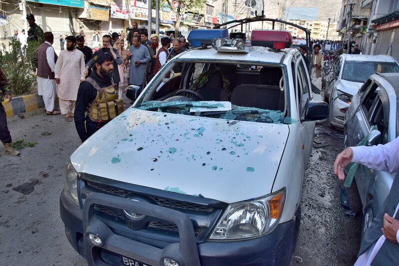 Officers examine a damaged police vehicle at the site of bomb blast, in Quetta, Pakistan, on Monday. AP