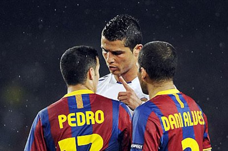 Cristiano Ronaldo argues with Pedro Rodriguez and Dani Alves of Barcelona during another hot-tempered game.