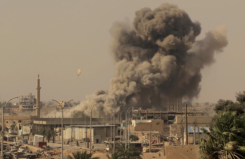 FILE PHOTO:Smoke rises after an air strike during fighting between members of the Syrian Democratic Forces and Islamic State militants in Raqqa, Syria August 15, 2017. REUTERS/Zohra Bensemra/File Photo