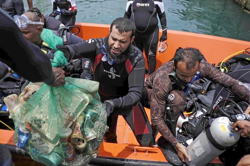 Volunteer divers collect trash from the ocean floor of the Abu Dhabi Free Port as part of the Dive Together To Protect Our Marine Environment’ initiative. Antonie Robertson/The National