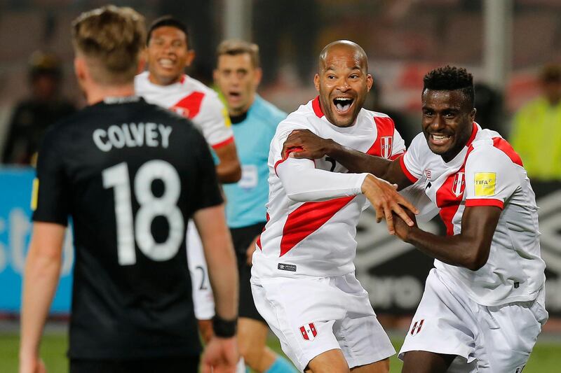 Peru's Christian Ramos, right,. celebrates after scoring his side's second goal against New Zealand, with his teammate Alberto Rodriguez , center, during a play-off qualifying match for the 2018 Russian World Cup in Lima, Peru, Wednesday, Nov. 15, 2017.  Peru won the match 2-0 and qualified for the World Cup for the first time in 36 years. (AP Photo/Karel Navarro)