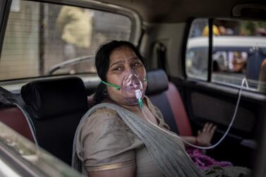  A Covid-19 patient sits in a car and breathes with the help of oxygen provided by a gurdwara, a Sikh house of worship, in New Delhi, India. AP